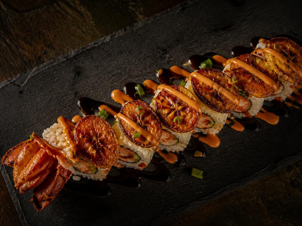 Caribbean lobster roll topped with fried plantain and spicy mayo